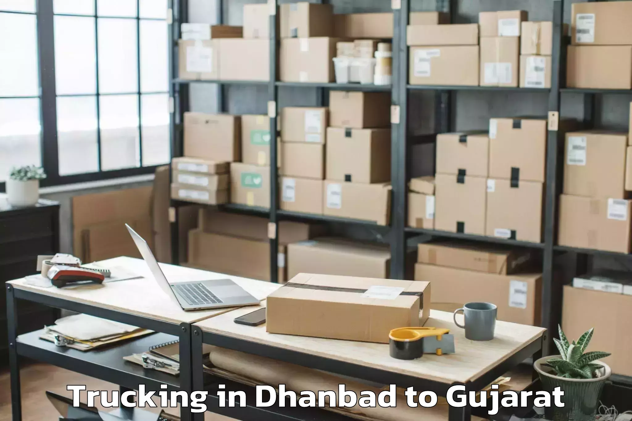 Leading Dhanbad to Gujarat University Of Transpla Trucking Provider